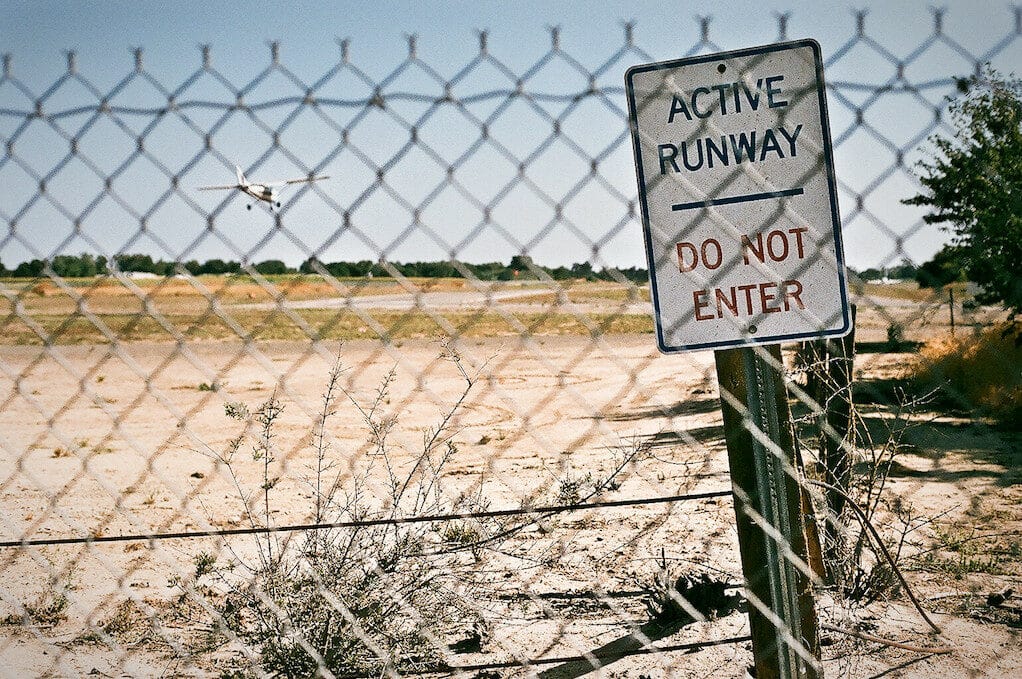 photo of a runway behind a fence