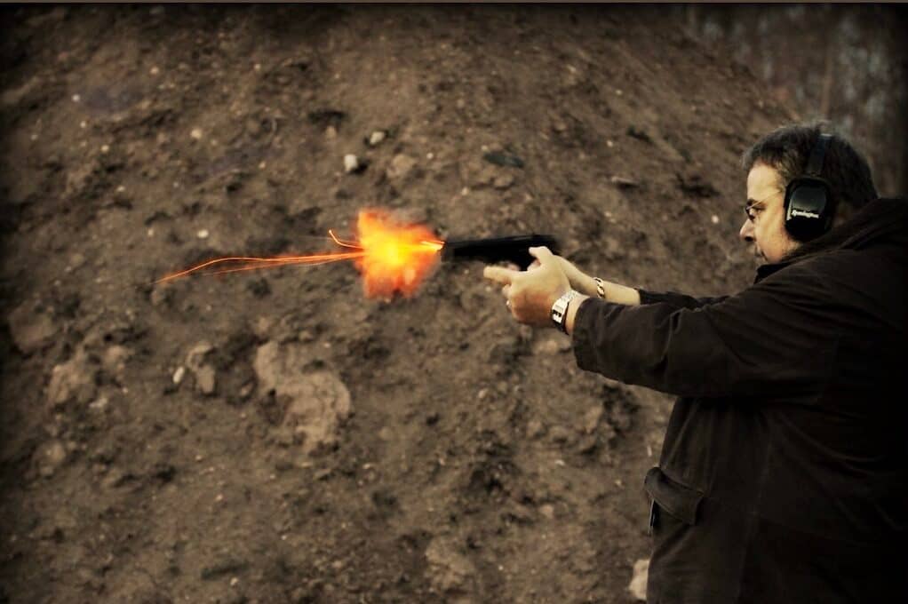 photo of a man firing a gun