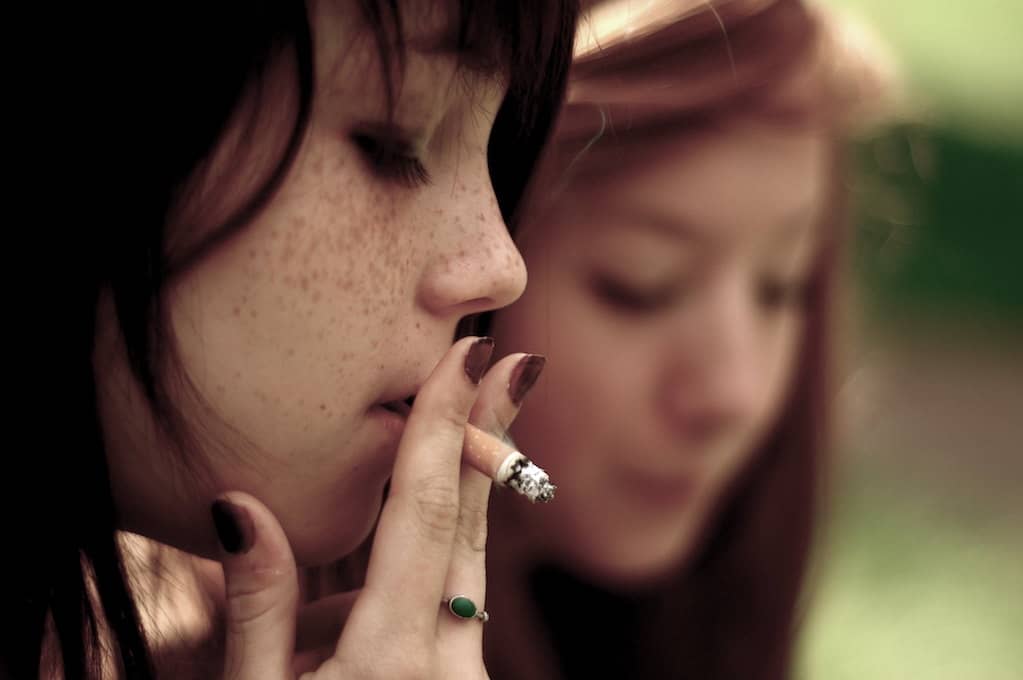 photo of a teenage girl smoking