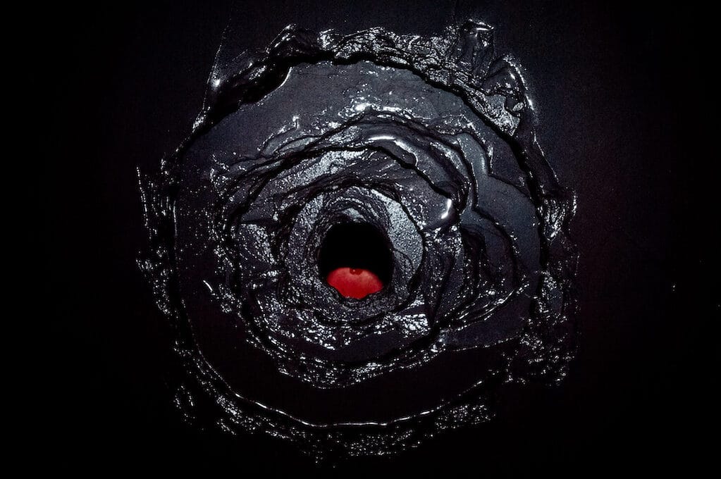 photo of dark hole with red at the bottom