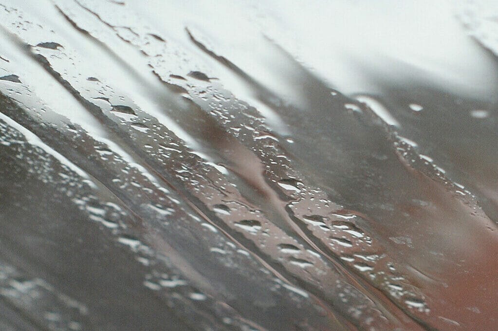 photo of rainwater droplets on glass