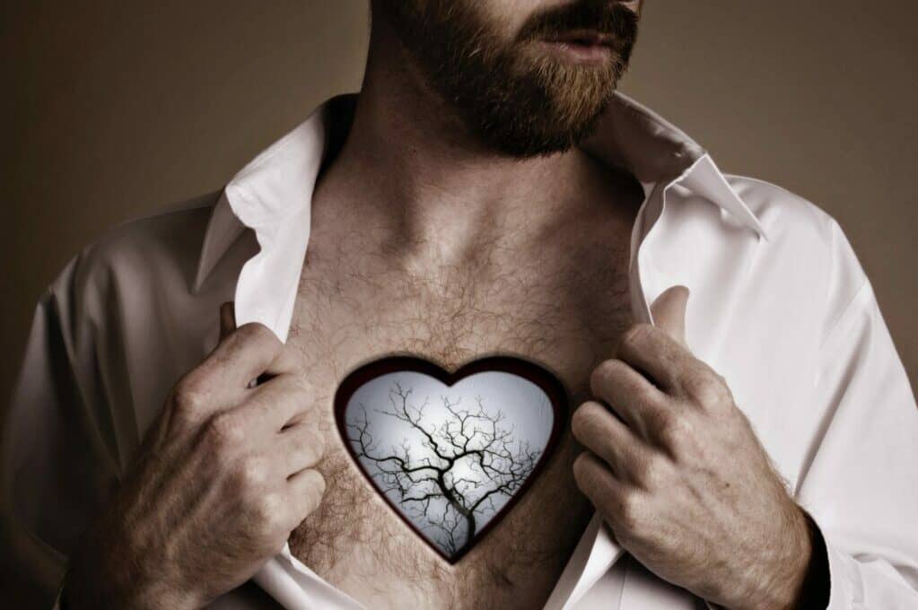 photo art of man with heart-shaped hole in chest