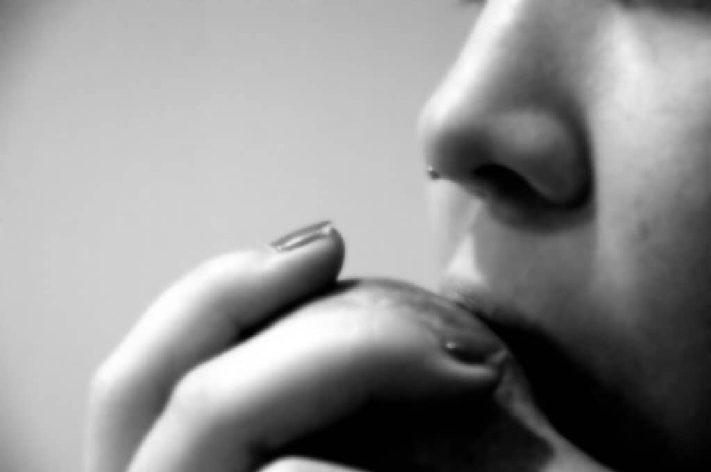 photo of a female biting into an apple