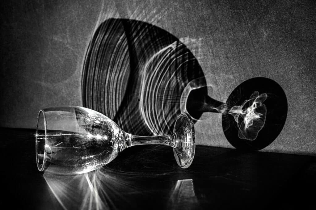black and white photo of wine glass with its reflection