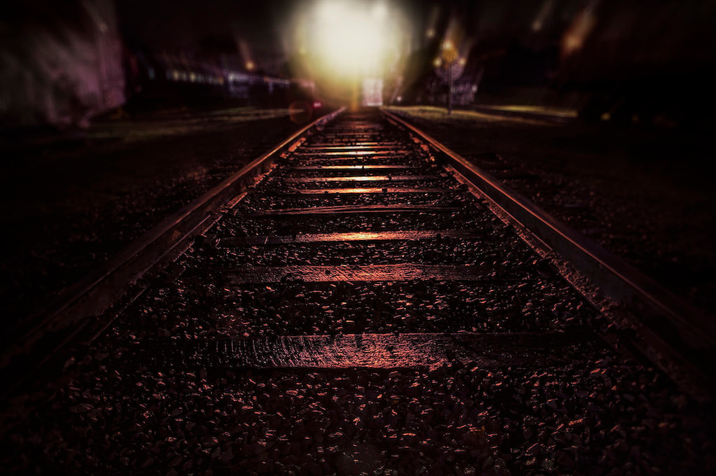 photo of train tracks at night