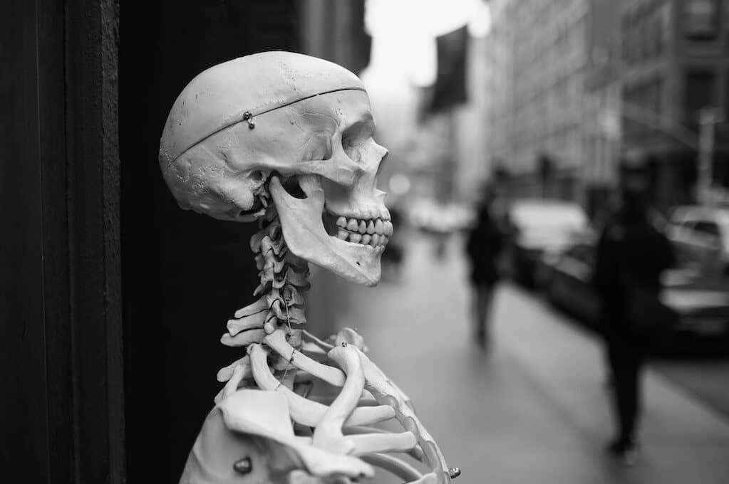 photo of skeleton in front of a store