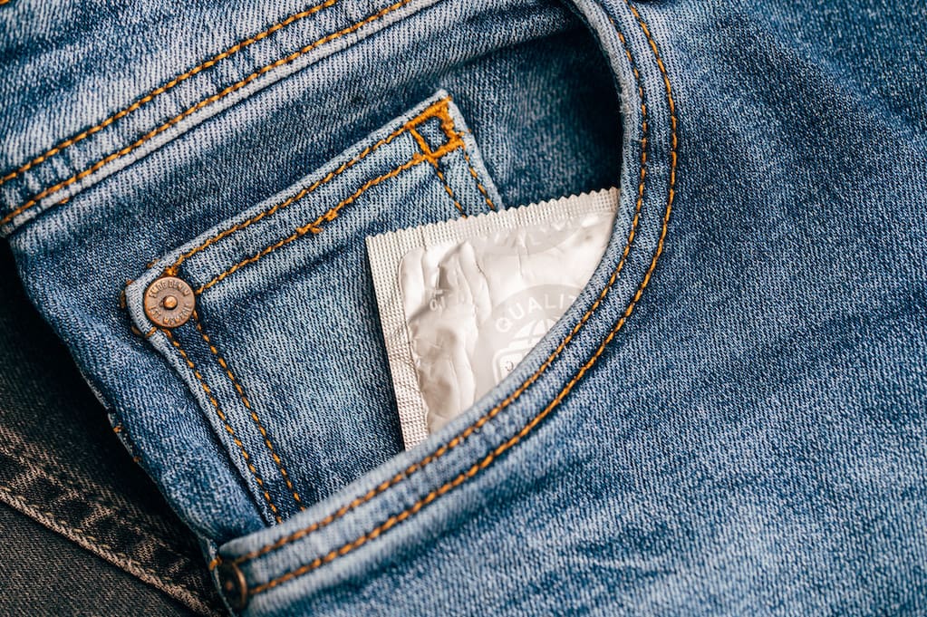 photo of condom in blue jeans pocket