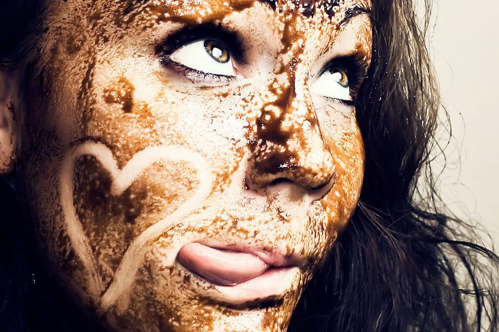 photo of woman with chocolate smeared all over her face