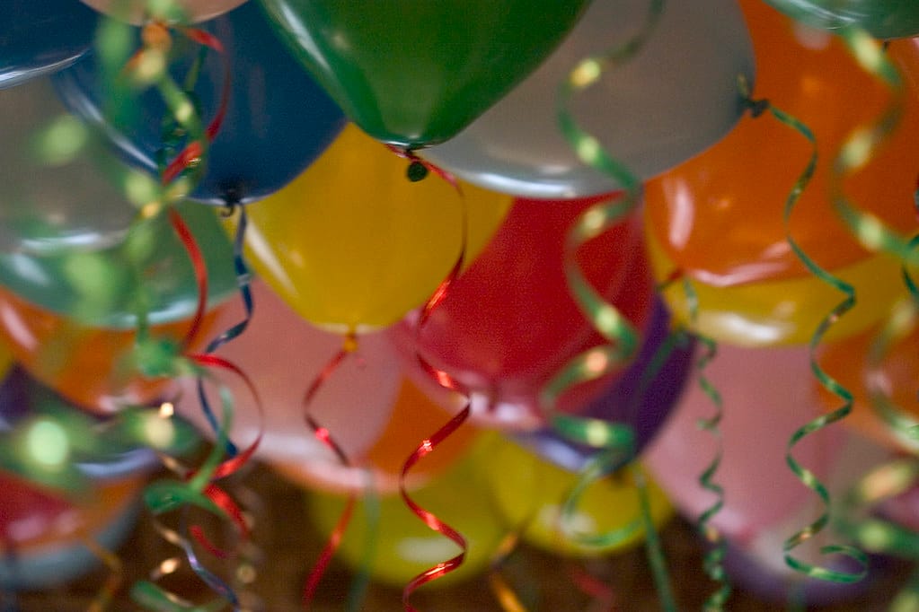 photo of party balloons with curly ribbons