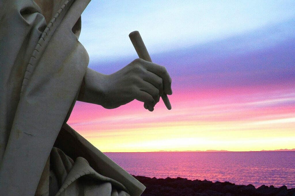 photo of a statue's hand holding a writing implement