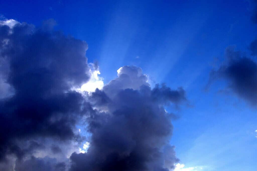 photo of sunlight peaking through clouds