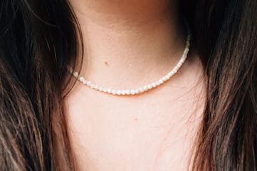 photo of female wearing pearl necklace