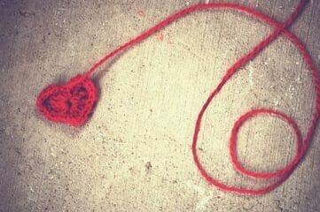 photo of red yarn ball wih heart at the end of skein