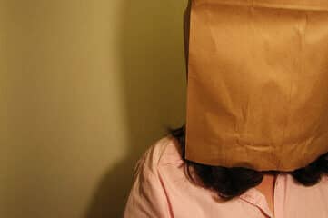 photo of woman with paper bag on her head