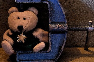 photo of teddy bear in a c-clamp
