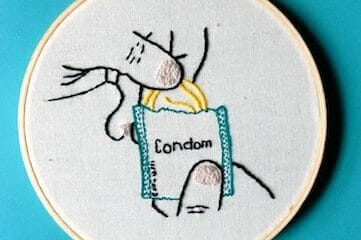 embroidery depicting hands opening a condom wrapper