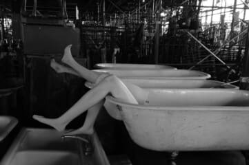 photo of mannequin legs sticking out of clawfoot tubs