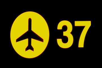 black and yellow sign with airport symbol and gate number