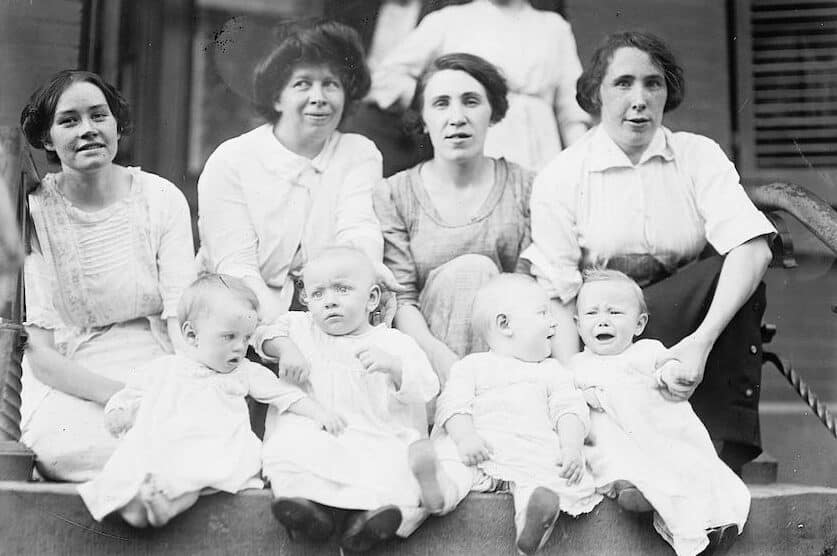 detail from old black and white photo of women holding babies